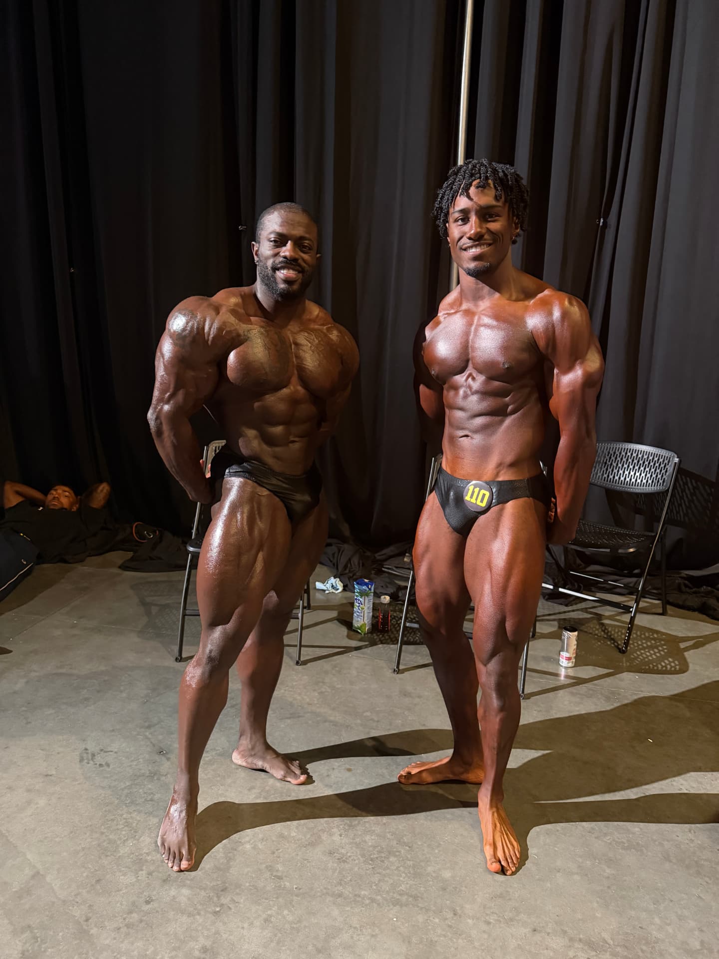 Marcellus Simmons backstage at a bodybuilding show with a client